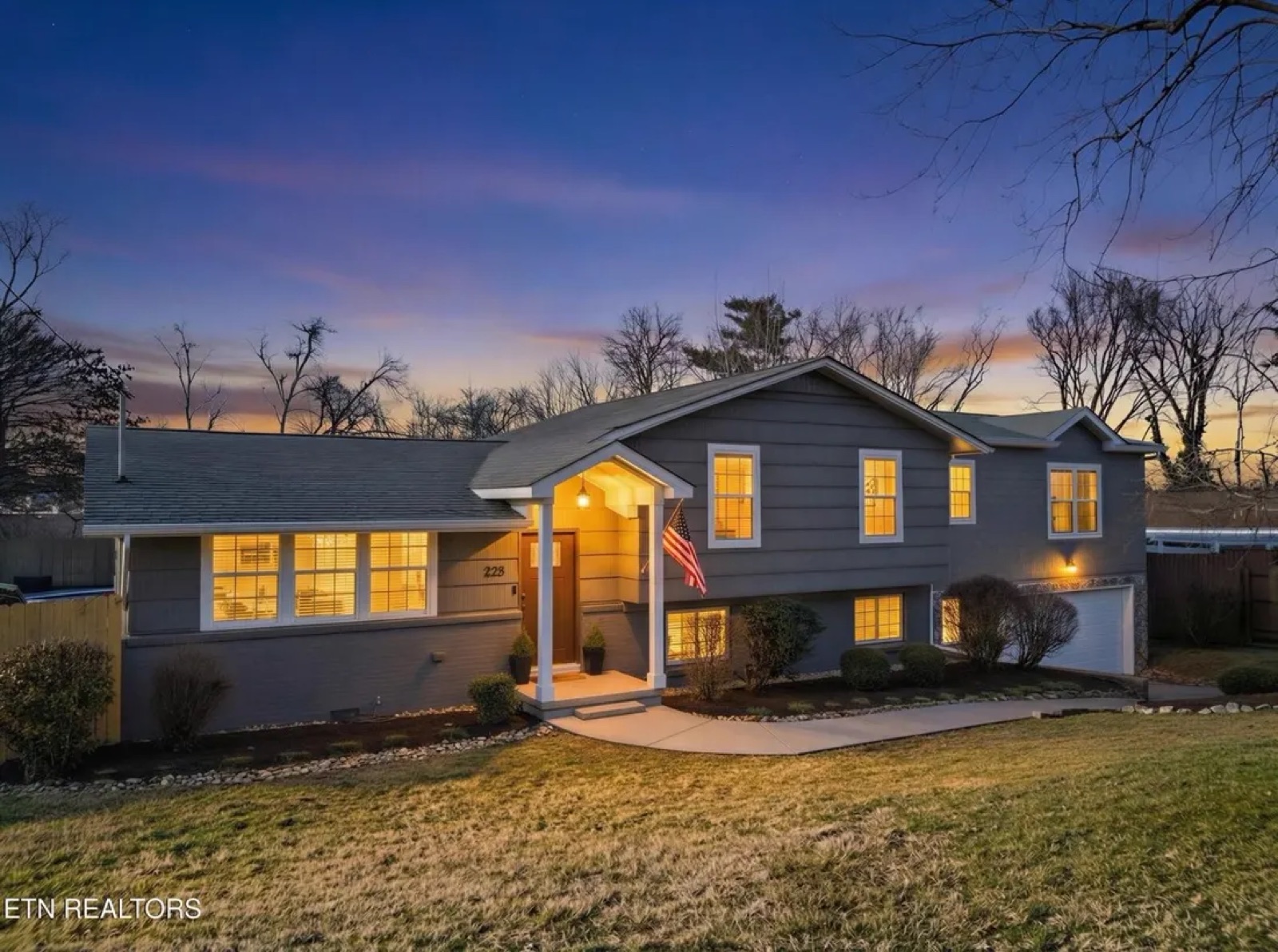 Two-story front exterior at dusk — before